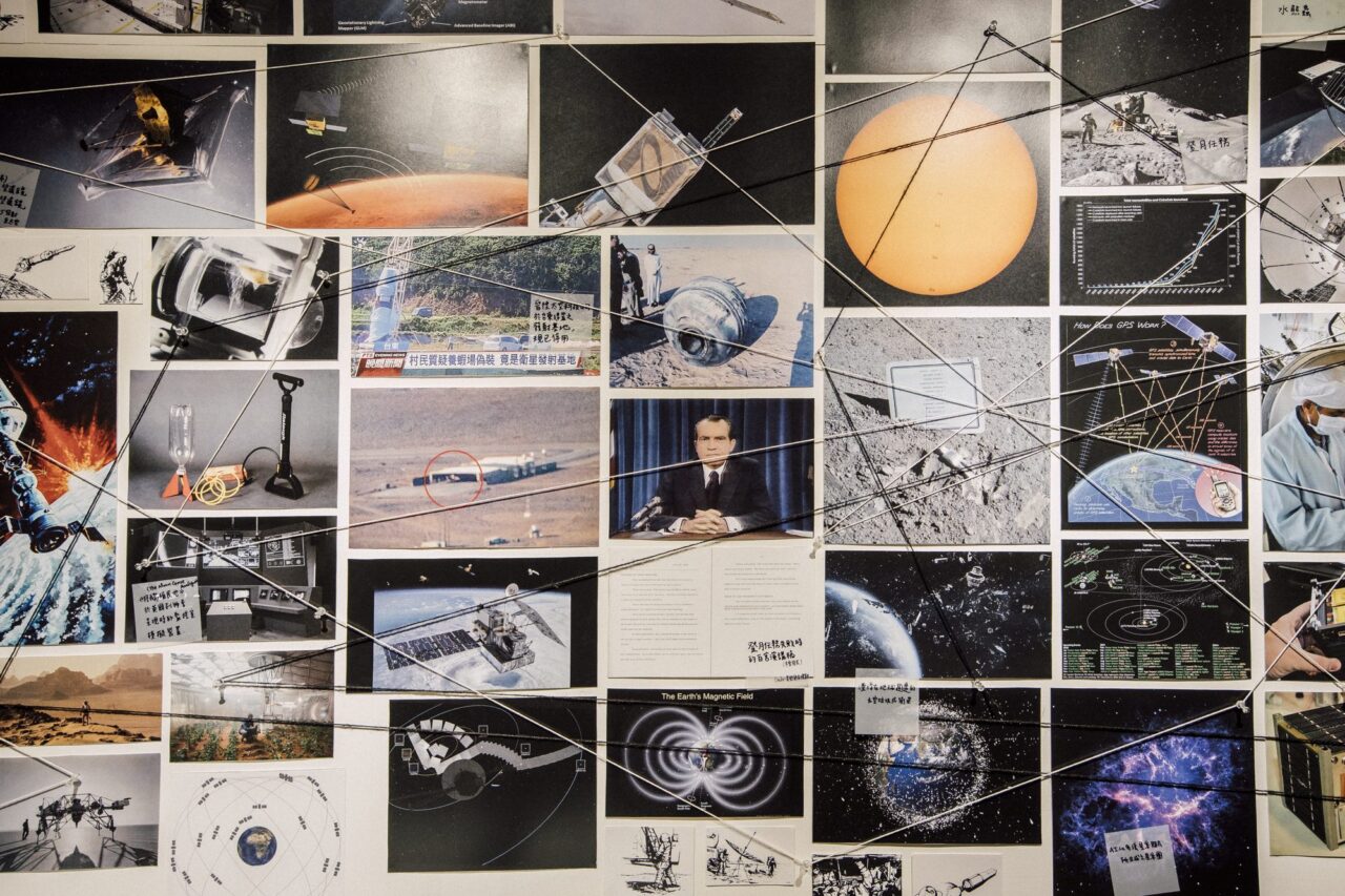 ENKOUNTER detail, archival images connected by string with handwritten annotations